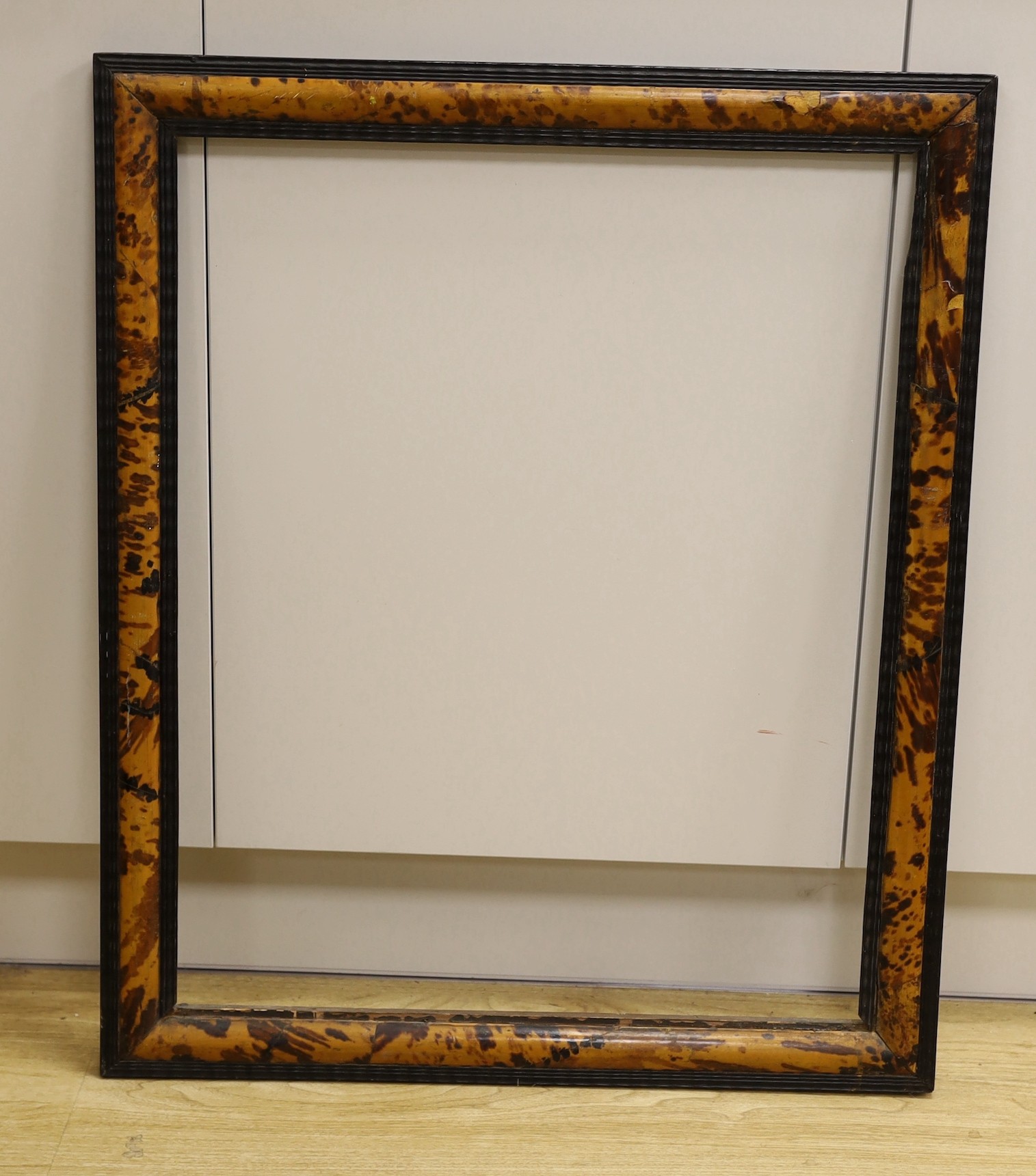 An 18th century Flemish blond tortoiseshell and ebonised picture frame, 78 x 64cm aperture 66 x 53cm